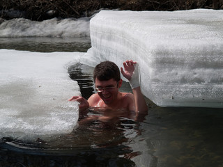 young man swimming among ice floats series 2