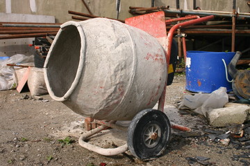 an old cement mixer in a builder's yard