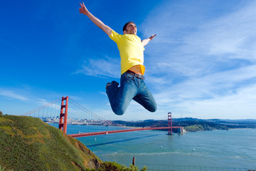 happy young man jumping high in the air