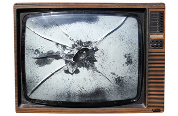 an old trashed tv with a smashed screen.