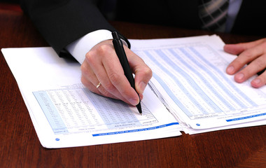 businessman is writing financial report