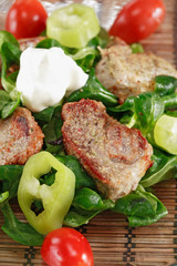 small steaks with salad and vegetable