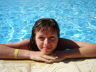 smiling girl in fresh water-pool on hot day