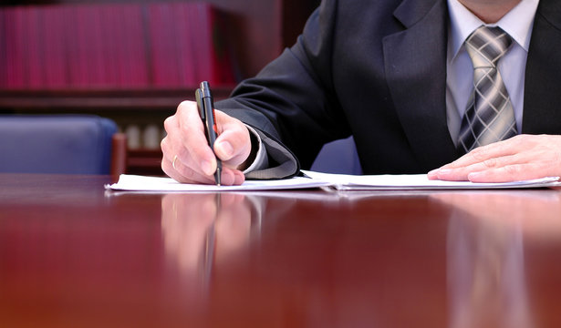 businessman is signing a contract