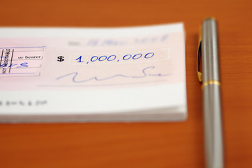 one million dollars cheque and a pen