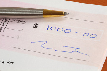 one thousand dollars cheque and a pen