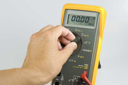 technician adjusting digital meter
