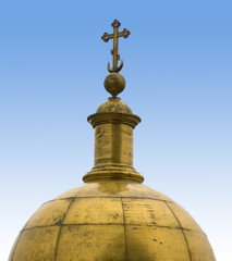 Fototapeta na wymiar cross on a golden dome and blue placid sky