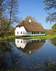 Fototapeta na wymiar reflection of old house in pond