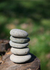 Fototapeta na wymiar zen stones balanced on log