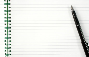 an open spiral notepad with blank lined paper and