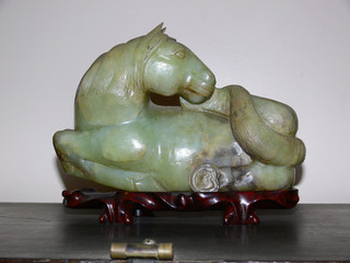 antique asian jade horse on teak bed © Sandra Chung