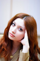 portrait of girl with reddish hair in office