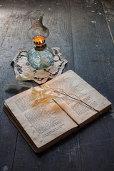 Obraz premium book of poetry and ancient oil lamp