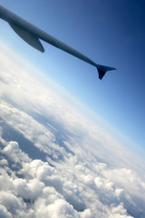 airplane wing over clouds