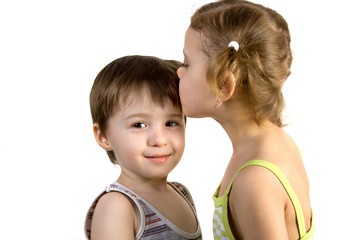 little girl kisses little boy