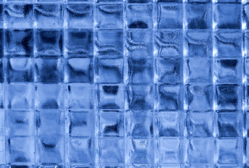 close up of blue glass squares in a window.