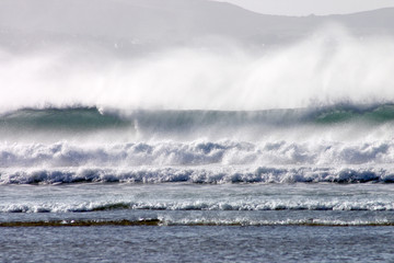 an atlantic wave breaking as it reached the shore.