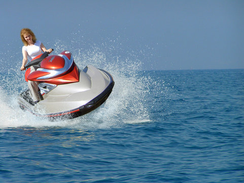 Young Woman Riding A Jet Ski