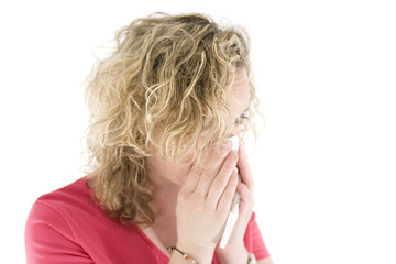 Fototapeta premium young blond girl sneezing in the handkerchief