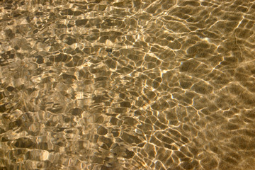 a pool of water on the beach with ripples and refl