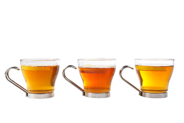 three glass cups of tea with one slice of lemon