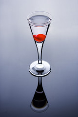 shot glass with vodka and cherry