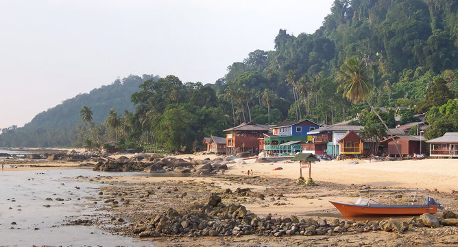 rocky tropical beach with some resorts, tioman islands, malaysia