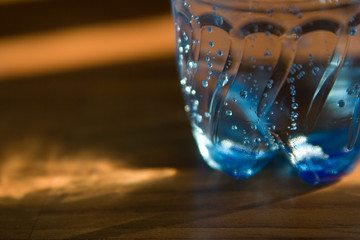 part of bottle with water on sun