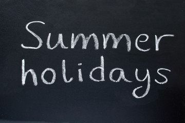 summer holidays, written on a school blackboard.