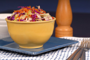 crisp cole slaw in a yellow bowl