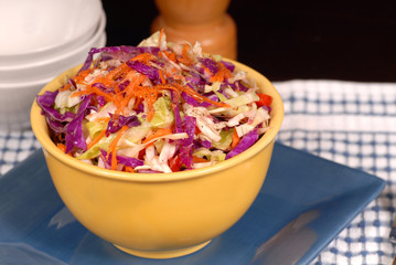 crisp cole slaw with carrot in a yellow bowl