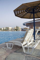 view at the resort pool with chairs and shade