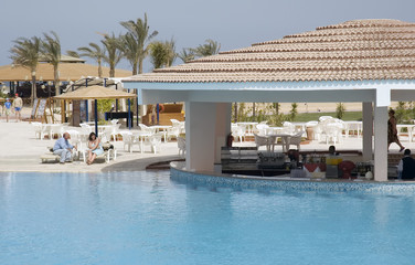 Fototapeta na wymiar resort pool bar with surrounding