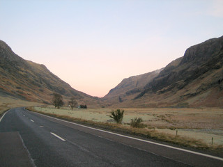 sunset on the open road in the scottish highlands