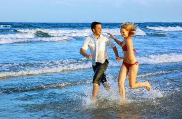couple enjoying themselves on the beach - 2856169