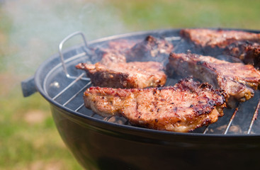 t-bone steak cooking on an open flame grill