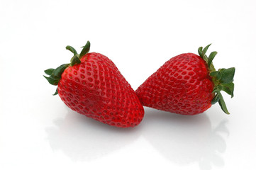 two strawberries with shadows