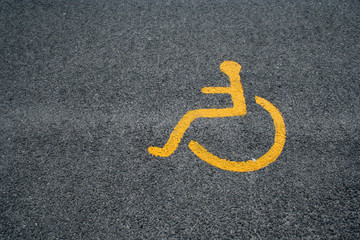 yellow sign for disabled parking