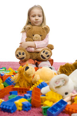 girl in the middle of toy-mess