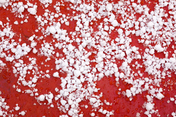 snow on a cowl of the red car