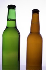 two beer bottles with no labals