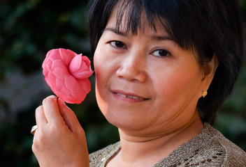 asian woman holding a flower