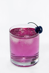 drink with blue cherry and ice on white background