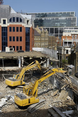 excavators on demolition site, london uk