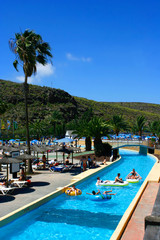 family having fun floating down the lazy river