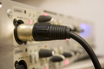 microphone lead plugged into equipment