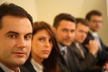 five business persons at a conference - portrait