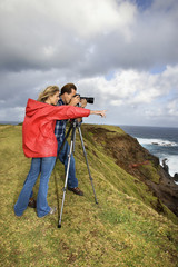 couple photographing scenery in maui, hawaii.