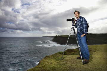 man photographing scenery in maui, hawaii.